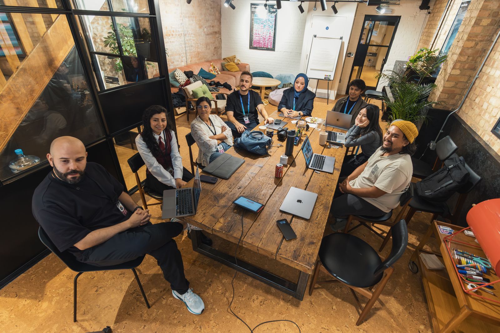 Consultants collaborating around a laptop in a modern office